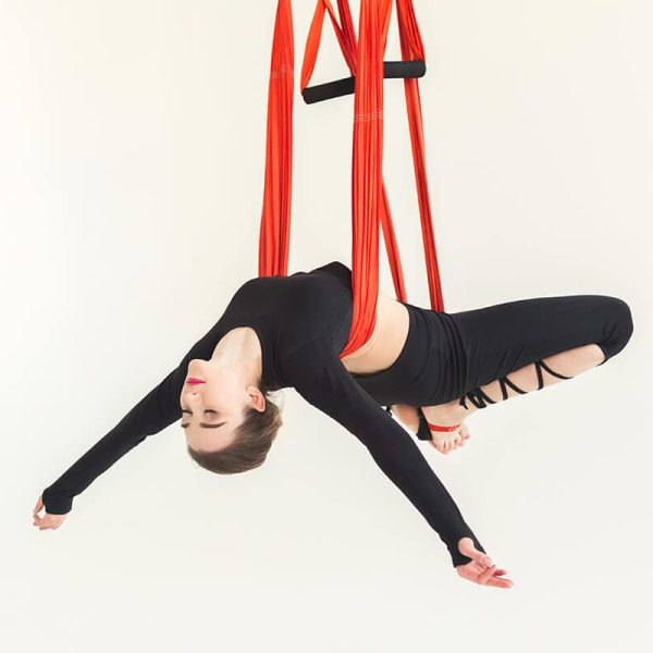woman-practicing-fly-yoga-over-white-background-FR2QM6N.jpg
